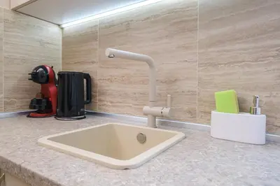 a kitchen counter with a sink in a room at Cozy Corner-Heart of Plovdiv in Plovdiv