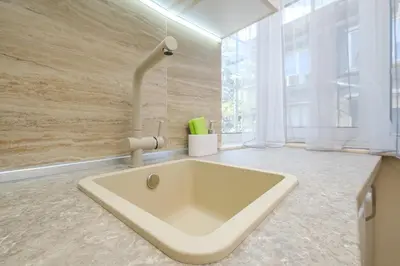 a large white sink in a bathroom with a window at Cozy Corner-Heart of Plovdiv in Plovdiv