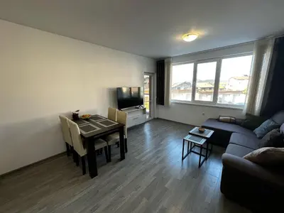 a living room with a table and a couch at Apartment Aria 6 in Velingrad