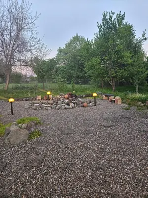 a fire pit with lights in the middle of a yard at Balkan Barn in Tŭzha
