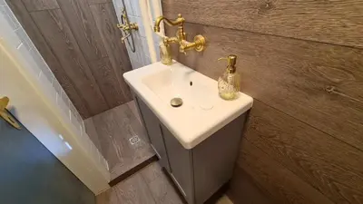 a bathroom sink with a bottle on top of it at Central 1-Bedroom Apartment with Balcony & View in Sofia