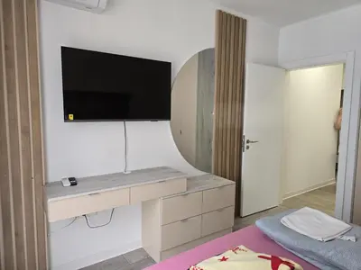 a bedroom with a tv on the wall and a bed at The Oligarchs Outlook in Sofia