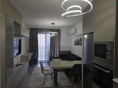 a room with a table and a living room with a couch at The Oligarchs Outlook in Sofia