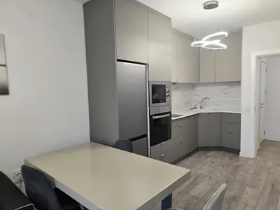 a kitchen with a white table and a refrigerator at The Oligarchs Outlook in Sofia