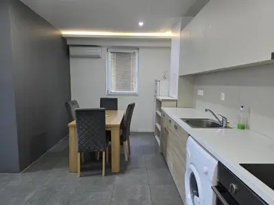 a kitchen with a table and a dining room at The Ascent in Sofia