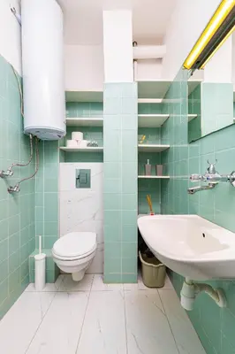 a bathroom with a toilet and a sink at Azuuro - 1BD near the city center by Flat Manager in Plovdiv