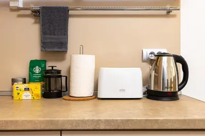 a kitchen counter with a coffee maker and a kettle at Azuuro - 1BD near the city center by Flat Manager in Plovdiv