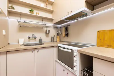 a kitchen with white cabinets and a sink at Azuuro - 1BD near the city center by Flat Manager in Plovdiv