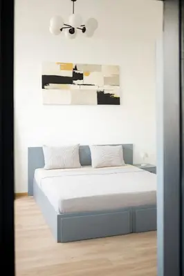 a bedroom with a bed with a ceiling fan at Sunny Top Floor Apartment near Tokuda Hospital & Paradise Mall in Sofia
