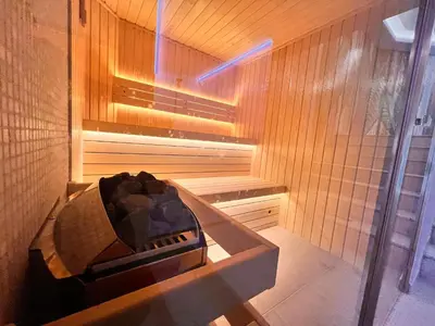 a sauna with a tub in a wooden wall at Ardo Hill Spa Hotel and Restaurant in Sarnitsa