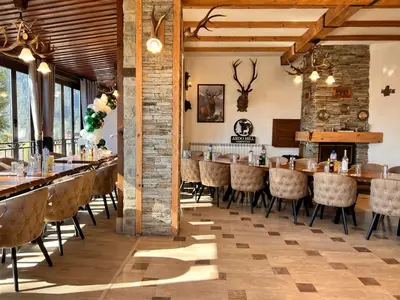 a dining room with a long table and chairs at Ardo Hill Spa Hotel and Restaurant in Sarnitsa