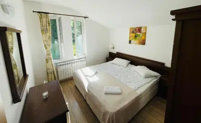 a bedroom with a bed and two windows at Forest Retreat, Stream Resort, Pamporovo in Stoykite
