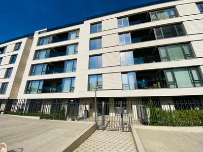 a large building with a fence in front of it at Business Park Premium, 2B lux flat, free garage in Sofia
