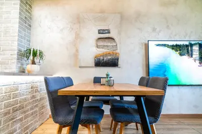 a dining room with a wooden table and chairs at Business Park Premium, 2B lux flat, free garage in Sofia
