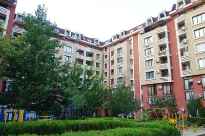 a large apartment building with a playground in front of it at Apartment-10 min from Sofia airport in Sofia