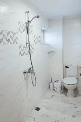a white bathroom with a shower and a toilet at Къща Инфинити Лукс и Уют, Вплетени в Спомени in Sapareva Banya