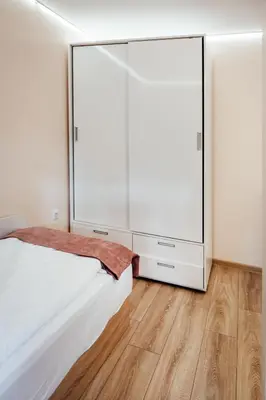 a bedroom with a large white bed and a large mirror at Къща Инфинити Лукс и Уют, Вплетени в Спомени in Sapareva Banya