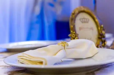 a plate with a napkin on a table with a mirror at Hotel Monte Cristo in Blagoevgrad