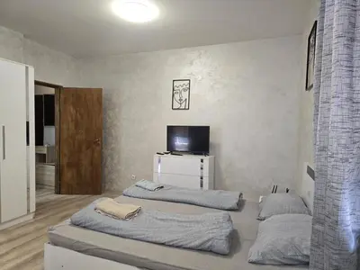 a room with three beds and a television in it at The Alma Mater in Sofia