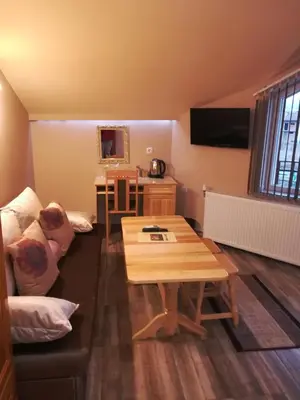 a living room with a coffee table and a couch at Guest House Edelweiss in Govedartsi