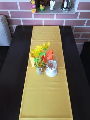 a table with flowers and a vase on it at Guest House Edelweiss in Govedartsi