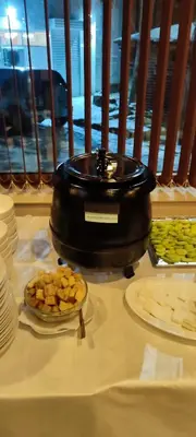 a table topped with plates of food and a bowl of food at Guest House Edelweiss in Govedartsi