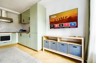 a kitchen with a flat screen tv on the wall at For Those Who Want the Best City Views and Style in Sofia