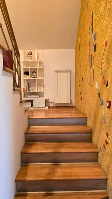 a room with a climbing wall and wooden stairs at Арт мезонет под тепето in Plovdiv