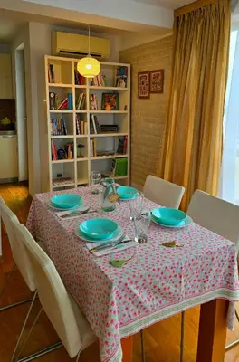 a dining room table with a polka dot table cloth at Арт мезонет под тепето in Plovdiv