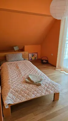 a bedroom with a bed with a pillow on it at Арт мезонет под тепето in Plovdiv