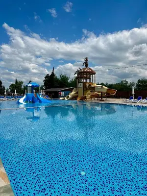 a large swimming pool with a slide and a water park at Комплекс Варвара - Хотел и Минерални басейни in Varvara