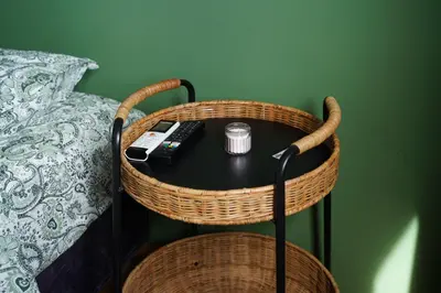 a table with a remote control on a table next to a bed at NDK Skyline Studio in Sofia