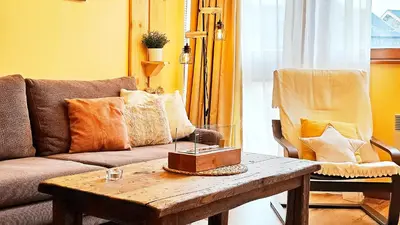 a living room with a couch and a coffee table at Forest nest Cozy apartment white balcony on the hill in Bansko