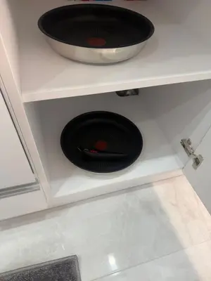a black sink in a white shelf with a bowl at White lux in Sandanski
