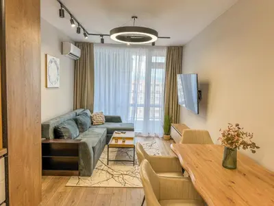 a living room with a couch and a table at 1BR Apartment with a Free Designated Parking Space in Plovdiv