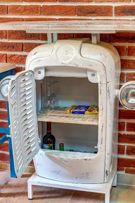 a refrigerator with its door open next to a brick wall at Into the Woods - Charming Studio by Flat Manager in Smolyan