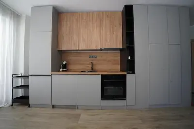a kitchen with white cabinets and a sink at Coziness and comfort in the heart of tranquility in Sofia