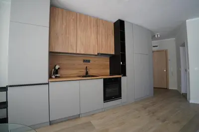a kitchen with white cabinets and a sink at Coziness and comfort in the heart of tranquility in Sofia