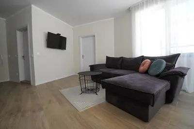 a living room with a couch and a table at Coziness and comfort in the heart of tranquility in Sofia