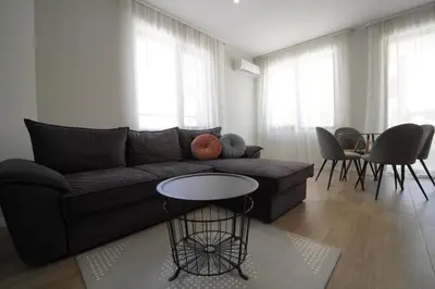 a living room with a couch and a table at Coziness and comfort in the heart of tranquility in Sofia