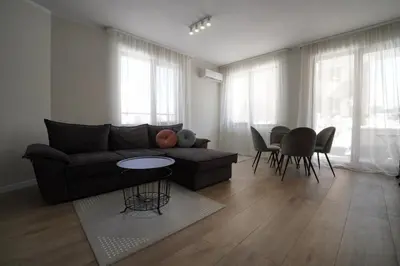 a living room with a couch and a table and chairs at Coziness and comfort in the heart of tranquility in Sofia