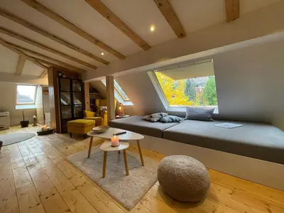 a bedroom with a large bed and a window at Boutique apartment with Mountain View in Sofia