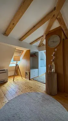 a living room with wooden floors and a ceiling with beams at Boutique apartment with Mountain View in Sofia
