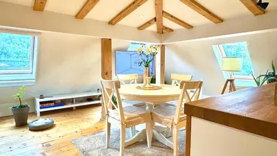 a dining room with a table and chairs at Boutique apartment with Mountain View in Sofia