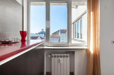 a kitchen with a window and a white radiator at Roca House in Sofia