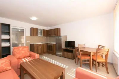 a living room with a couch and a table at Вилно селище Тракия- почивка сред природата in Tsigov Chark