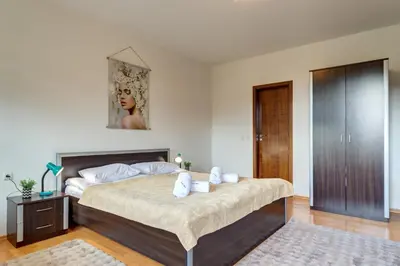 a bedroom with a large bed with white pillows at Pamporovo Palace - 2BD next to the Ski Slopes by Flat Manager in Pamporovo