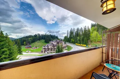 a balcony with a view of a mountain at Pamporovo Palace - 2BD next to the Ski Slopes by Flat Manager in Pamporovo