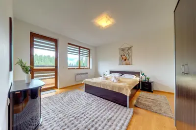 a bedroom with a bed and a television in it at Pamporovo Palace - 2BD next to the Ski Slopes by Flat Manager in Pamporovo