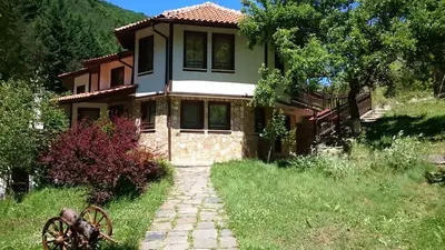 a house with a stone path in front of it at Villa Persenk in Lyaskovo